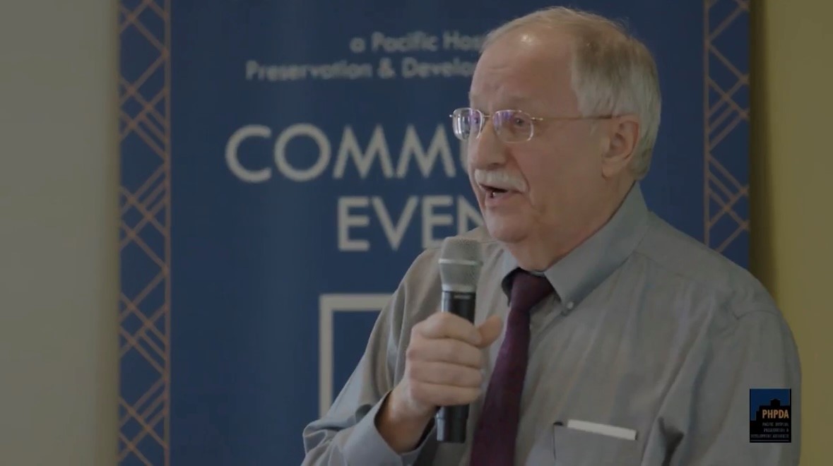 Frank Chopp speaking on a microphone
